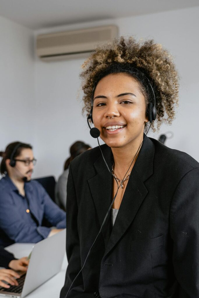 Lawyer virtual receptionist smiling with headset while assisting clients in a professional office environment